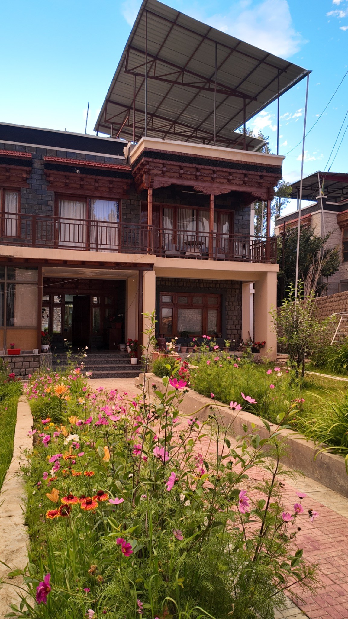 Flower-filled garden walkway outside the house