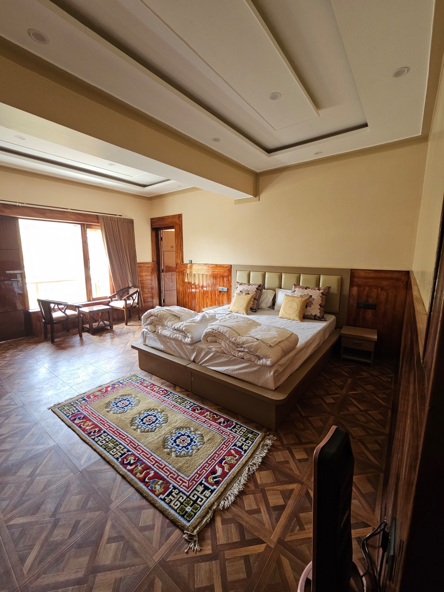 Premium bedroom with wooden interiors and a patterned rug