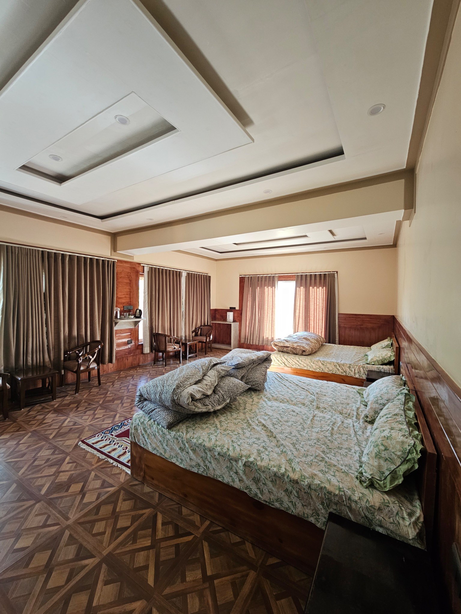 Room with two beds and wooden floor